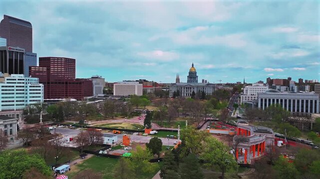 City of Denver Civic Center Park event center downtown Lodo Capitol Hill Colorado Capitol buildings aerial drone cityscape spring cloudy blue sky afternoon cars traffic forward upwards