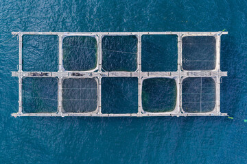 Floating fish farming cages seen by drone over lake © WILL PHOTOGRAPHY