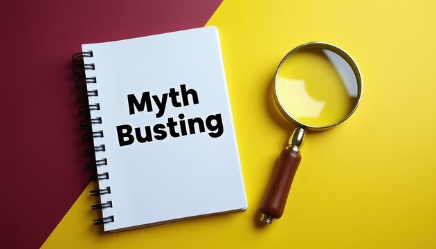 Flat lay concept with notepad labeled Myth Busting and magnifying glass on vibrant yellow and maroon background. Investigation, research, and fact checking idea.