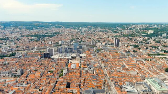 Nancy, France. the UNESCO-listed Place Stanislas and the city's terracotta rooftops, revealing the neoclassical square, modern Tour Thiers, and the railway district under bright summer sun. Drone foo