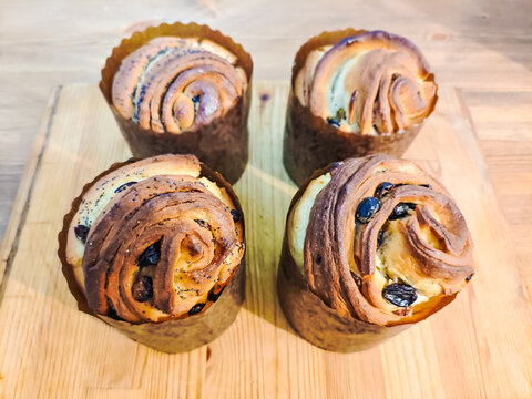 Freshly Baked Cruffins with Raisins on a Wooden Table