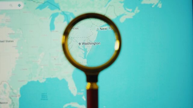 Magnifying glass exploring united states map and washington