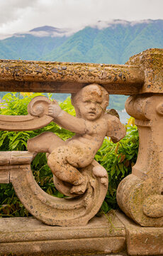 cherub angel in stone wall near lake como, italy