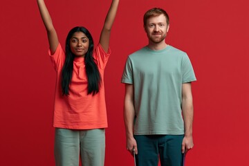Obraz premium Close portrait of smiling diverse duo on red backdrop for promotional banner background and advertising design