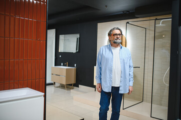Mature man shopping for bathroom rennovation in store