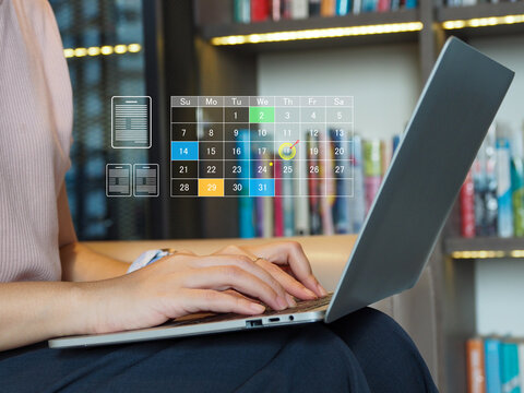 Woman typing on laptop with transparent digital calendar overlay showing scheduled dates and icons, focused on planning and productivity in cozy library workspace