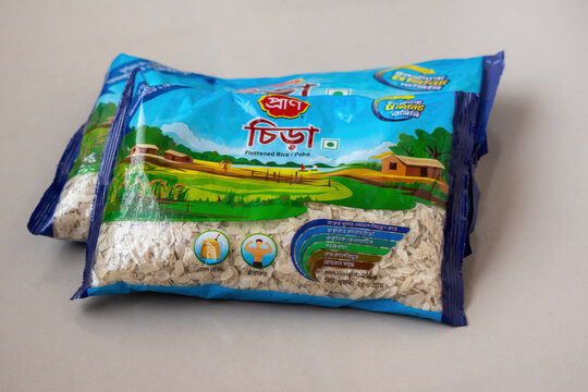 Kishoreganj, Bangladesh - 22 April, 2026 - Two packets of PRAN brand flattened rice or poha displayed on a floor. This popular FMCG product represents common consumer goods in South Asia.