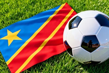Naklejka premium Congo flag and soccer ball on green grass