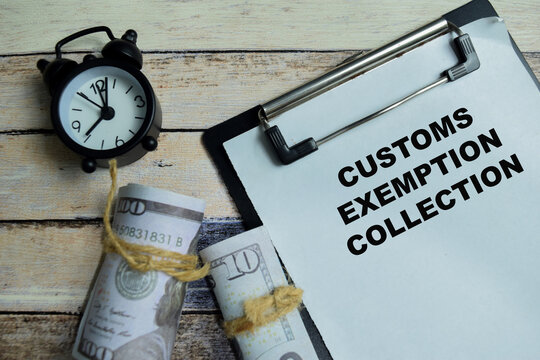 Concept of customs exemption collection write on clipboard isolated on Wooden Table. For international trade and financial