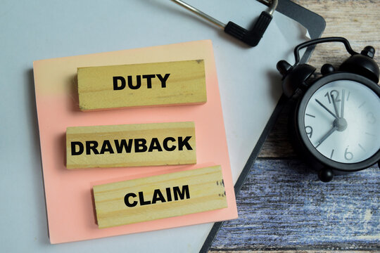Concept of text duty drawback claim on wooden blocks. For international trade refunds and financial recovery