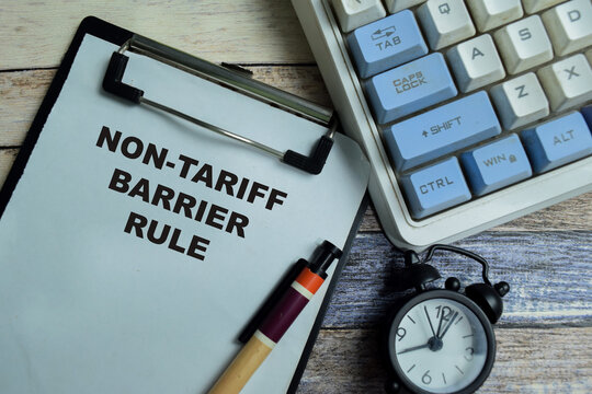 Concept of non-tariff barrier rule write on clipboard isolated on Wooden Table. For international trade regulations and protectionism