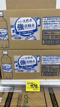 Iga no Tennen Sui Strong Sparkling Water case stacks on display at a supermarket with price tag and Japanese beverage branding - Osaka, Japan, July 07, 2025