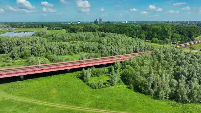 Aerial footage of the Hanzeboog (Hanseatic Arch), a combined railway and cycle bridge spanning the IJssel river. The bridge was opened in June 2011