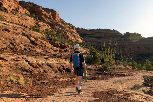 Solo hiker exploring a red rock landscape