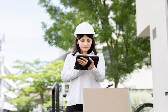 Technician female with helmet checking work