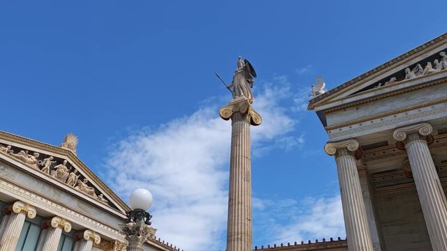 Panoramic tilt of the Academy of Athens. Elegant marble figures and divine sculptures are unveiled against drifting white clouds, embodying timeless Greek heritage.