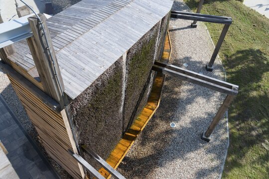 Modern wooden structure with gravel floor and shade, surrounded by vegetation, brine, graduation tower, health resort Miłomłyn, Milomlyn, Liebem&uuml;hl, Warmia-Masuria, Poland