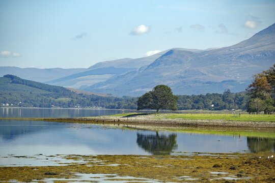 A tranquil loch surrounded by mountains with a peaceful natural landscape in the background, Loch Eil, Ben Nevis, Scotland, United Kingdom