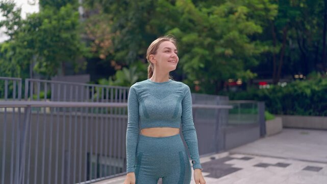 Caucasian young beautiful sportswoman running on the rooftop garden. 