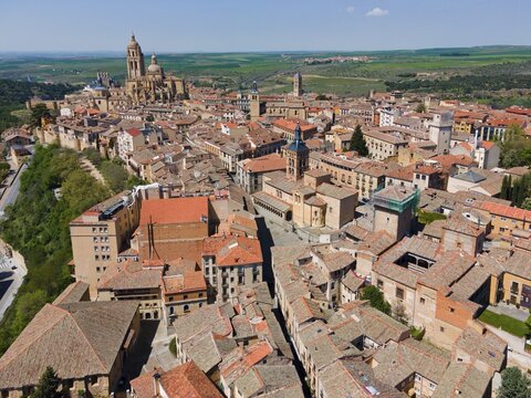 Aerial view of a historic city with large churches surrounded by red tiled roofs and green fields in the hinterland, Aerial view, Cathedral, Segovia, Castilla y Le&oacute;n, Leon, Spain