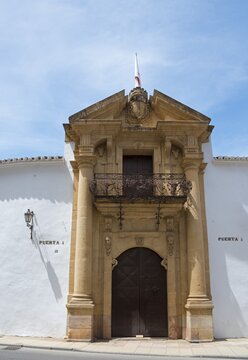 Historic stone entrance gate with decorated coat of arms and balcony in Spanish town, Plaza de Toros, bullring, old town, Ronda, M&aacute;laga province, Malaga, Andalusia, Spain
