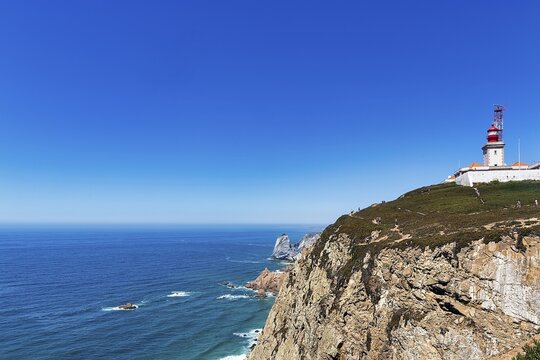 Lighthouse on rocky coast on the Atlantic Ocean, Farol do Cabo da Roca, Cabo da Roca, Sintra, Lisbon District, Portugal