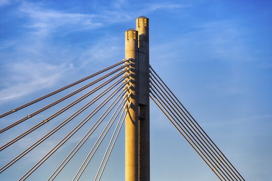 Pylon and steel cables of the suspension bridge J&auml;tk&auml;nkynttil&auml;, wooden lumberjack candle bridge, modern architecture, midnight sun, blue sky, close-up, Rovaniemi, near Arctic Circle, Lapland, Finland