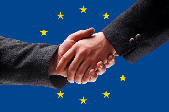 Men shaking hands against European union flag