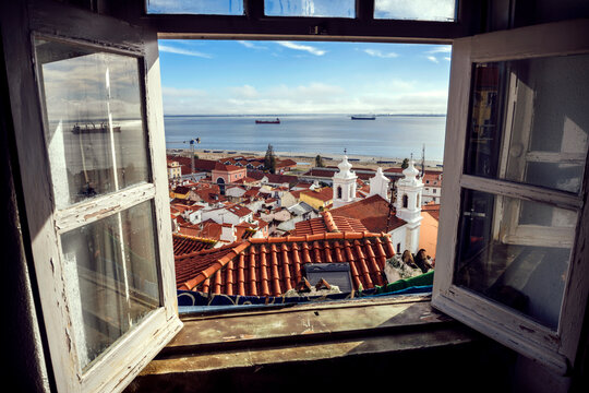 Portugal, Lisbon, view of Alfama neighborhood and River Tejo through open window