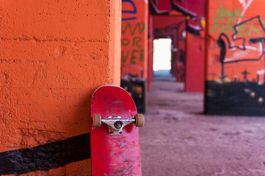 Germany, North Rhine Westphalia, Duisburg, Skateboard against graffiti sprayed wall