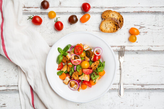 Panzanella made of roasted Ciabatta, rocket, red onions, tomatoes and basil