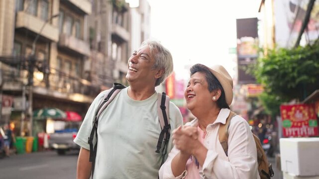 Asian senior couple traveler traveling and exploring the city outdoors. 