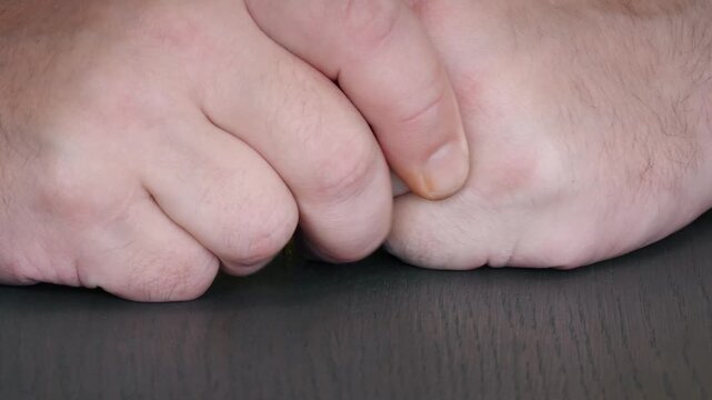 Nervous hand rubbing close up showing fidgeting and anxiety in a quiet setting