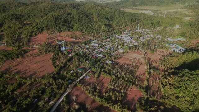 Scenic aerial orbit over Hawan Grande, Catanduanes, revealing a quaint barangay village amid farmland, coconut groves, and lush island greenery