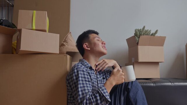 Man takes peaceful coffee break while sitting on the floor