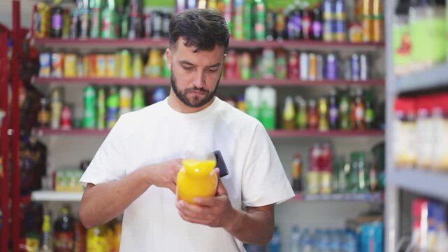 Male customer scans barcode code on soft drinks in grocery store. High quality 4k footage