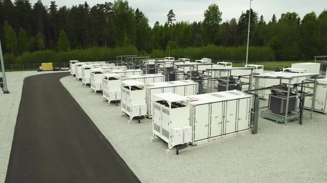 Aerial footage of a modern BESS facility with rows of battery containers used for storing renewable energy, an essential component of a smart grid for sustainable power and decarbonization