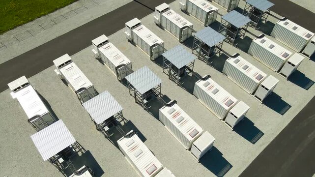 Drone view of a stationary battery energy storage system featuring containerized units, an innovative solution for storing power from renewable sources like solar and wind for grid stability