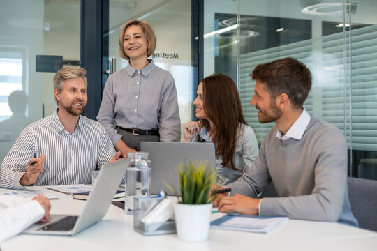 Group of happy progressive business people working on startup together at creative office