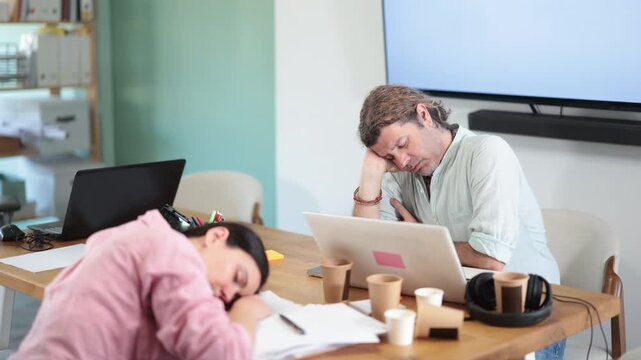 Tired female office worker having nap while sitting in his workplace. High quality 4k footage