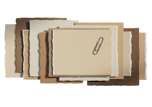 A stack of brown envelopes with a paperclip on top
