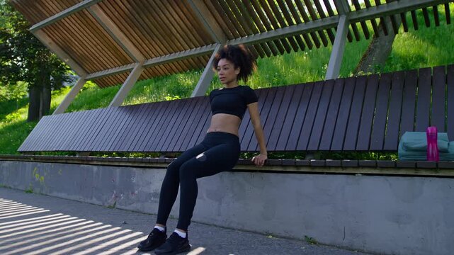 Woman Doing Bench Triceps Dips Outdoors
