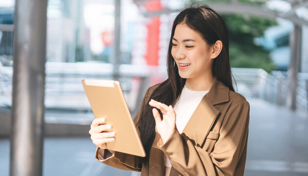 Business asian woman using digital tablet for internet browsing urban city lifestyles