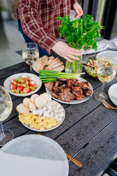 Vertical food table with grilled meat cheese salad and fresh herbs
