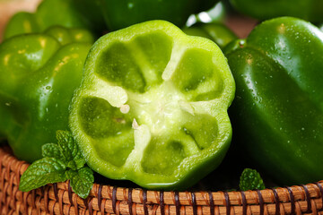 Fresh Green Bell Peppers in Wicker Basket - Healthy Organic Vegetables for Cooking © NgoVan