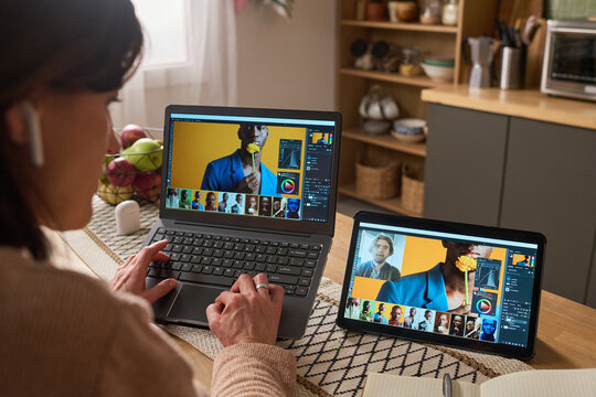 African American senior man and Caucasian middle aged woman learning online at home, using laptop for digital skills training and lifelong education. Useful for e learning, reskilling, remote study