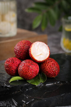 Fresh Lychee Fruits from Guangxi Hainan China Showing Sweet White Flesh and Red Skin on Dark Marble Surface