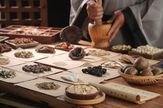 Chinese Medicine Practitioner Formulating Traditional Herbal Remedies with Ancient Healing Ingredients