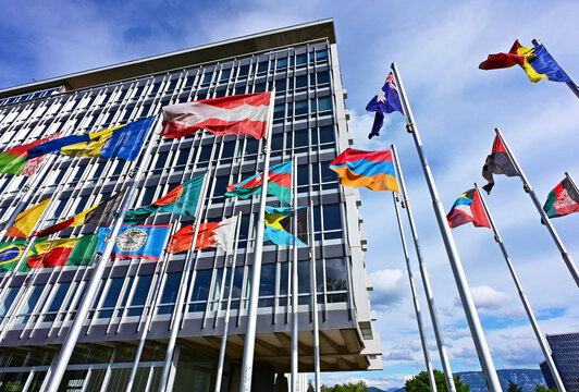 Geneva, Switzerland, Europe - 05.2026 : National flags of members of World Health Organization in front of headquarters building, specialized agency of United Nations