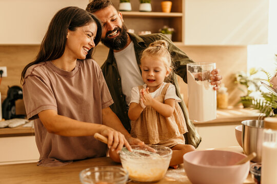 Happy family baking together in kitchen having fun